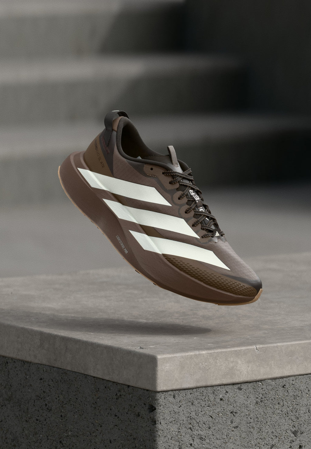 ADIZERO EVO SL ATR M - Trainers - earth strata/off white/warm sandstone