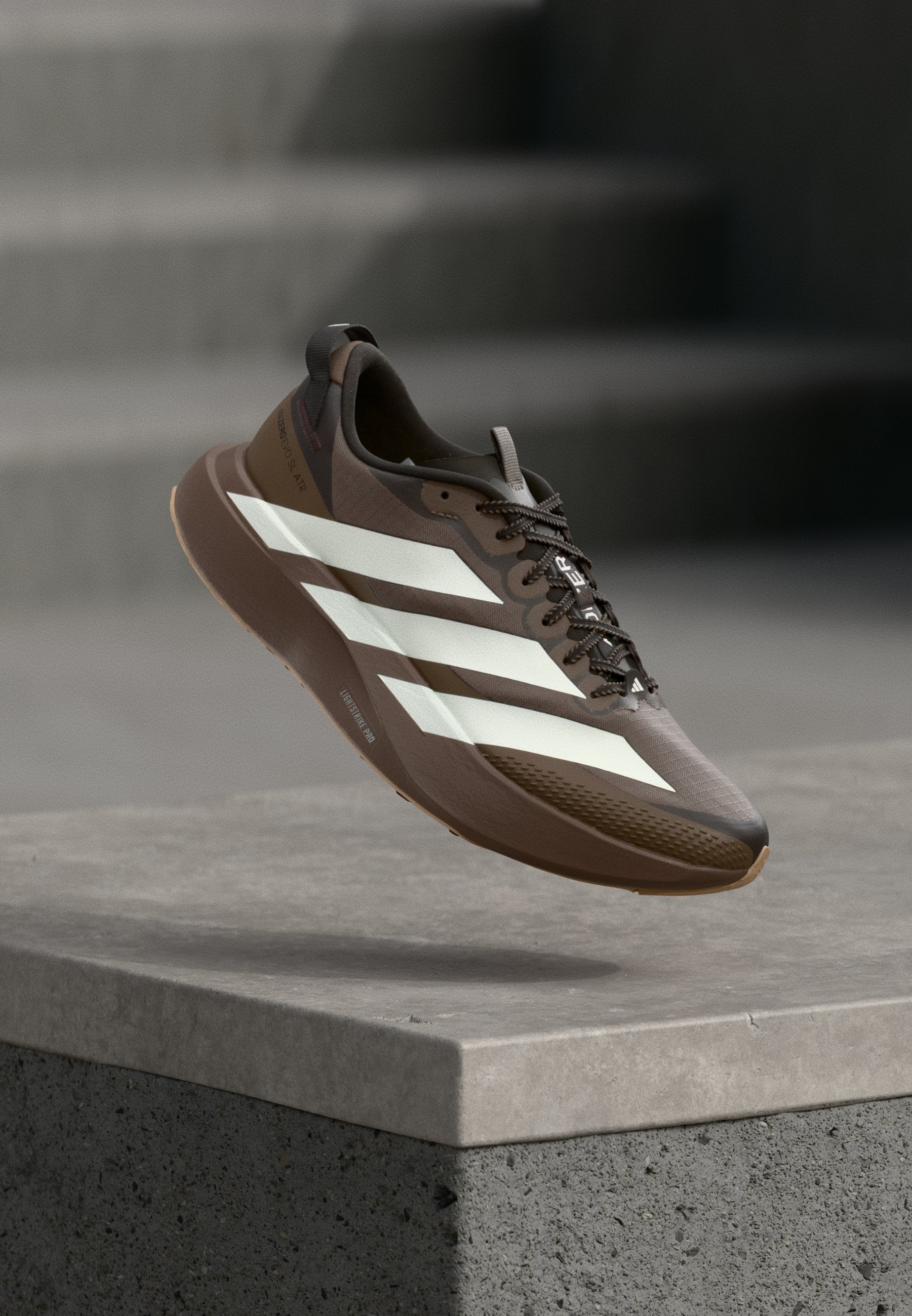 ADIZERO EVO SL ATR M - Trainers - earth strata/off white/warm sandstone