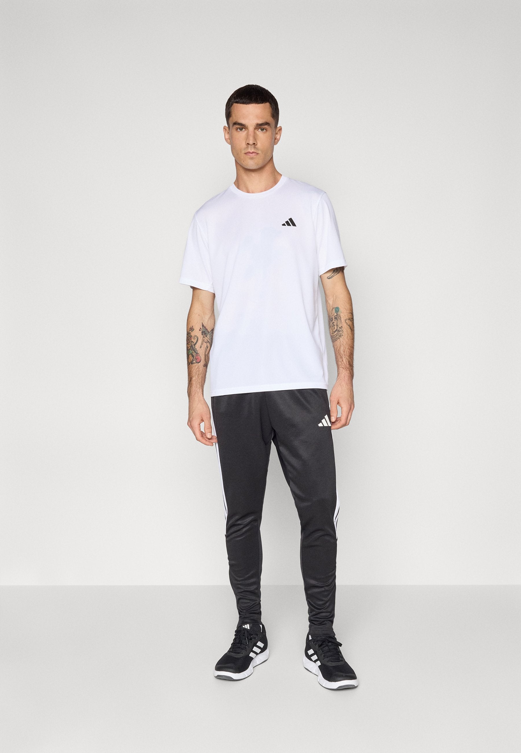 TIRO - Tracksuit bottoms - black/white