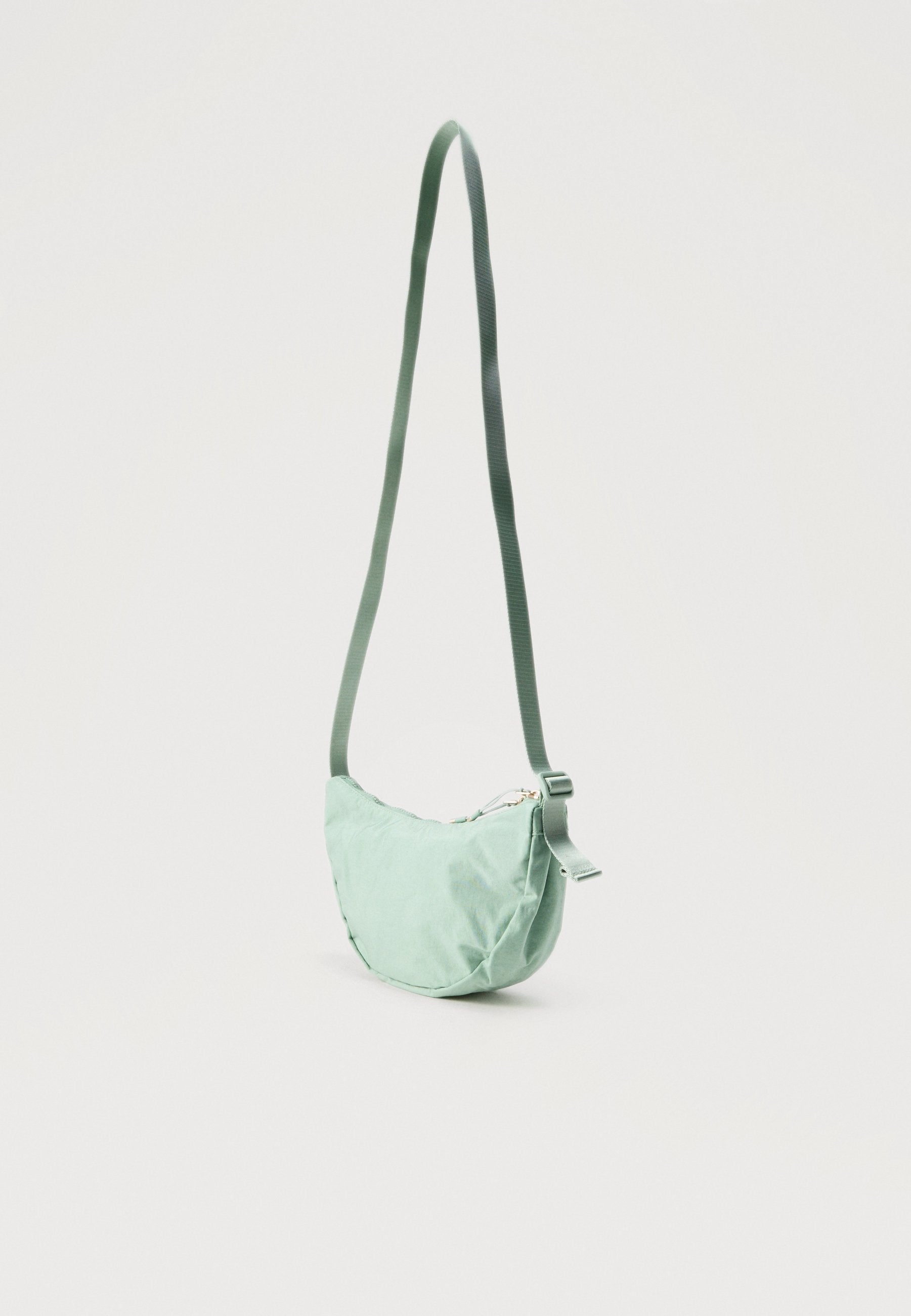 AURA CRESCENT CROSSBODY UNISEX - Cross body bag - mint/gold-coloured