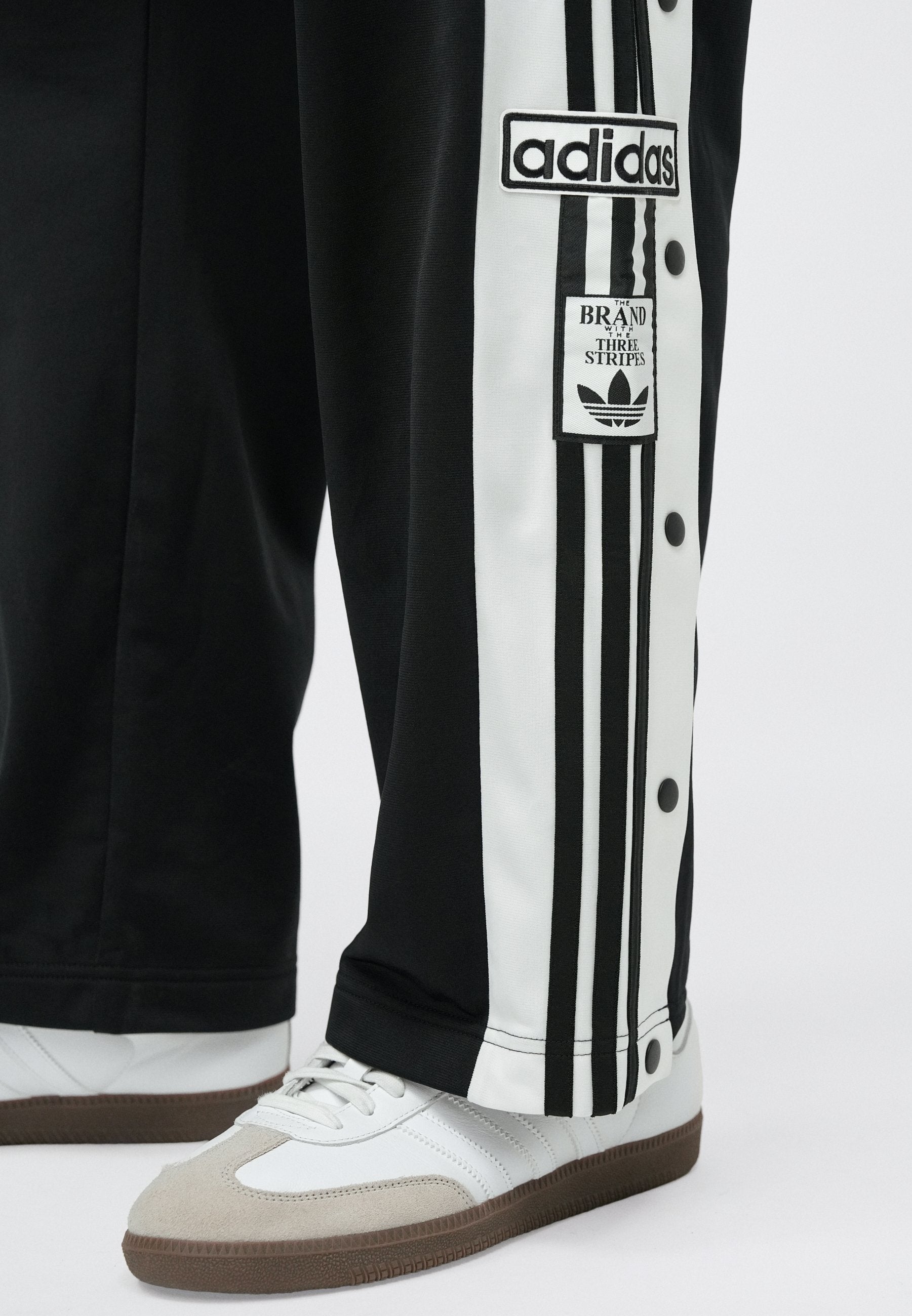 ADIBREAK UNISEX - Tracksuit bottoms - black/white