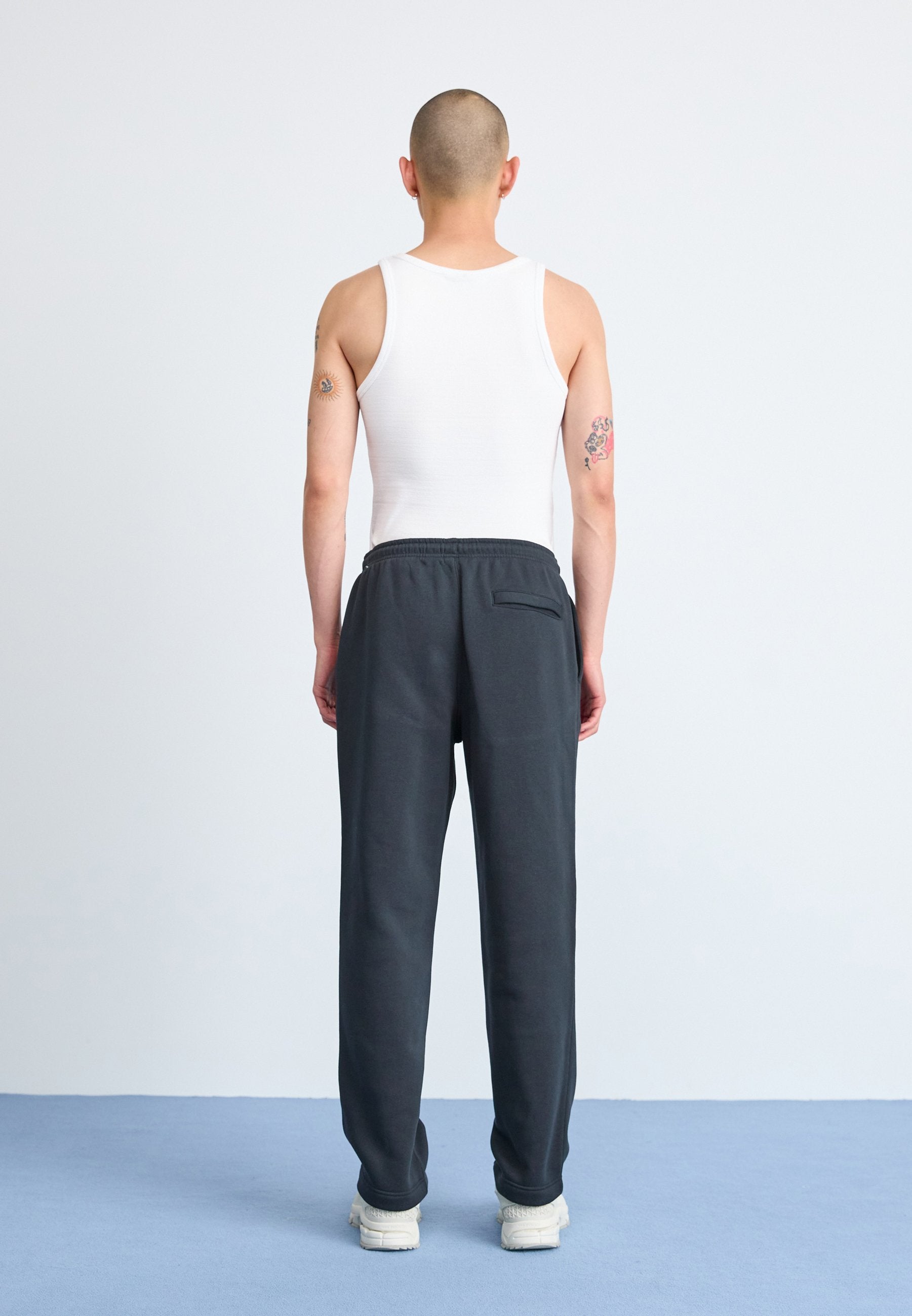CLUB - Tracksuit bottoms - black