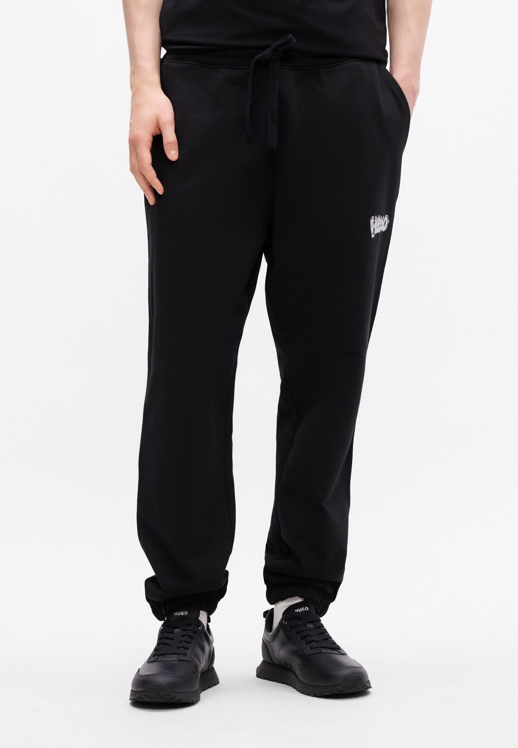 NYROTRO - Tracksuit bottoms - black