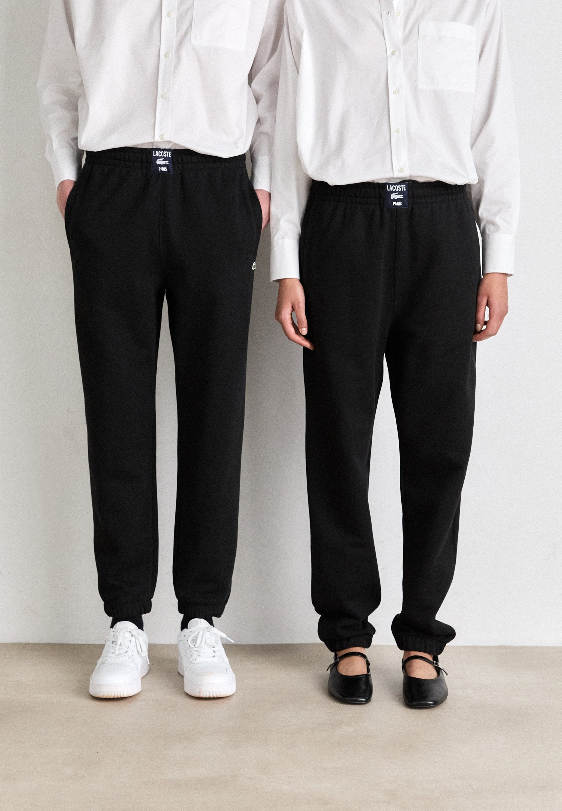 UNISEX - Tracksuit bottoms - black