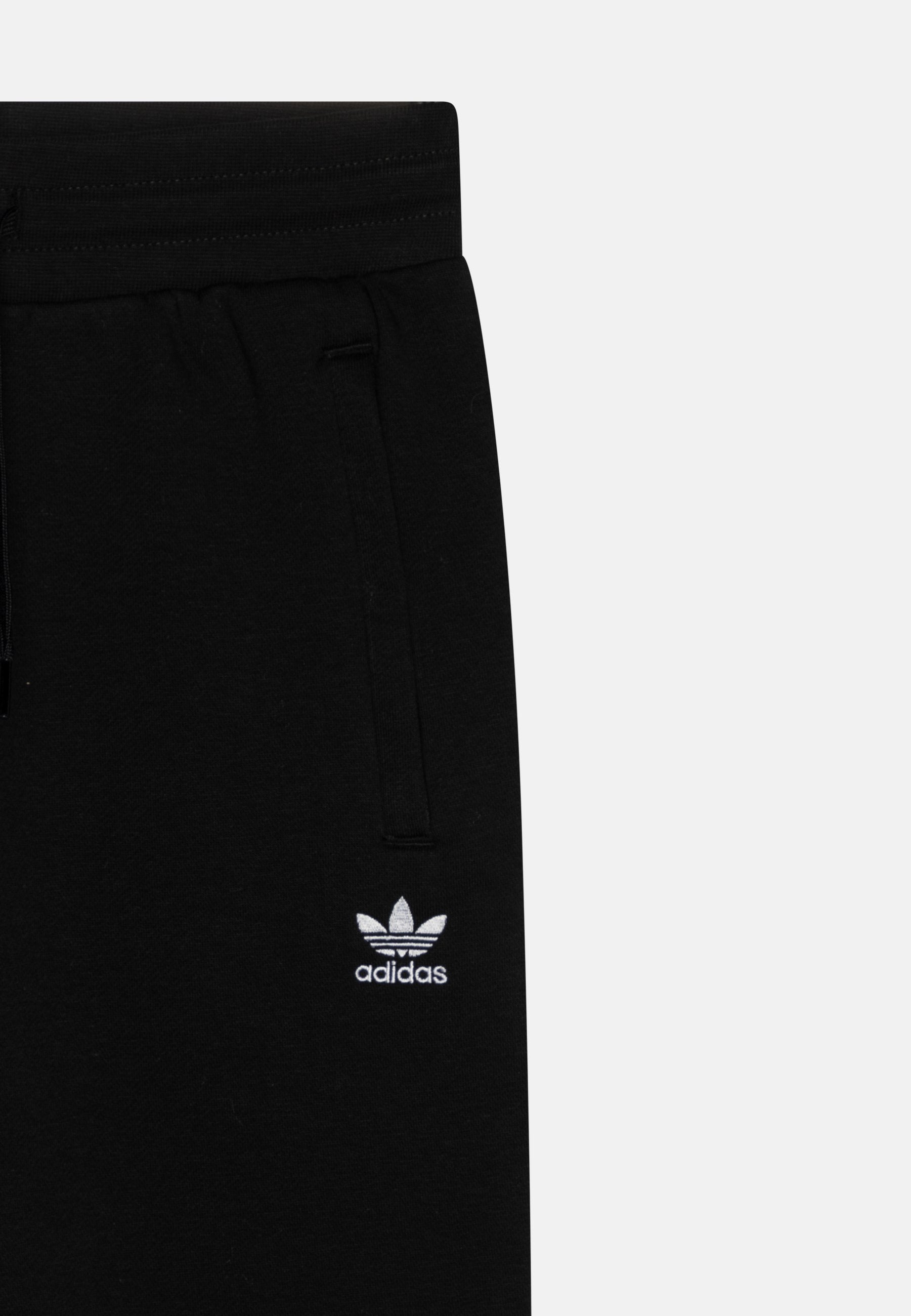 JUNIOR  - Tracksuit bottoms - black