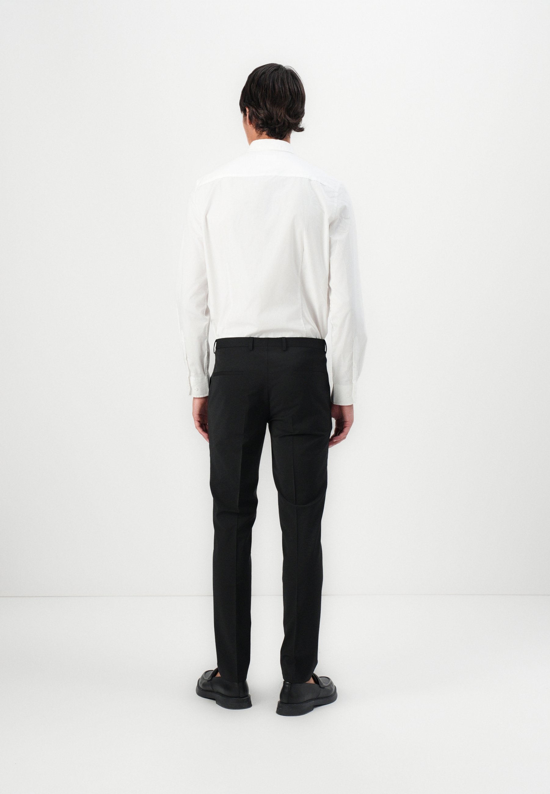 HESTEN - Trousers - black