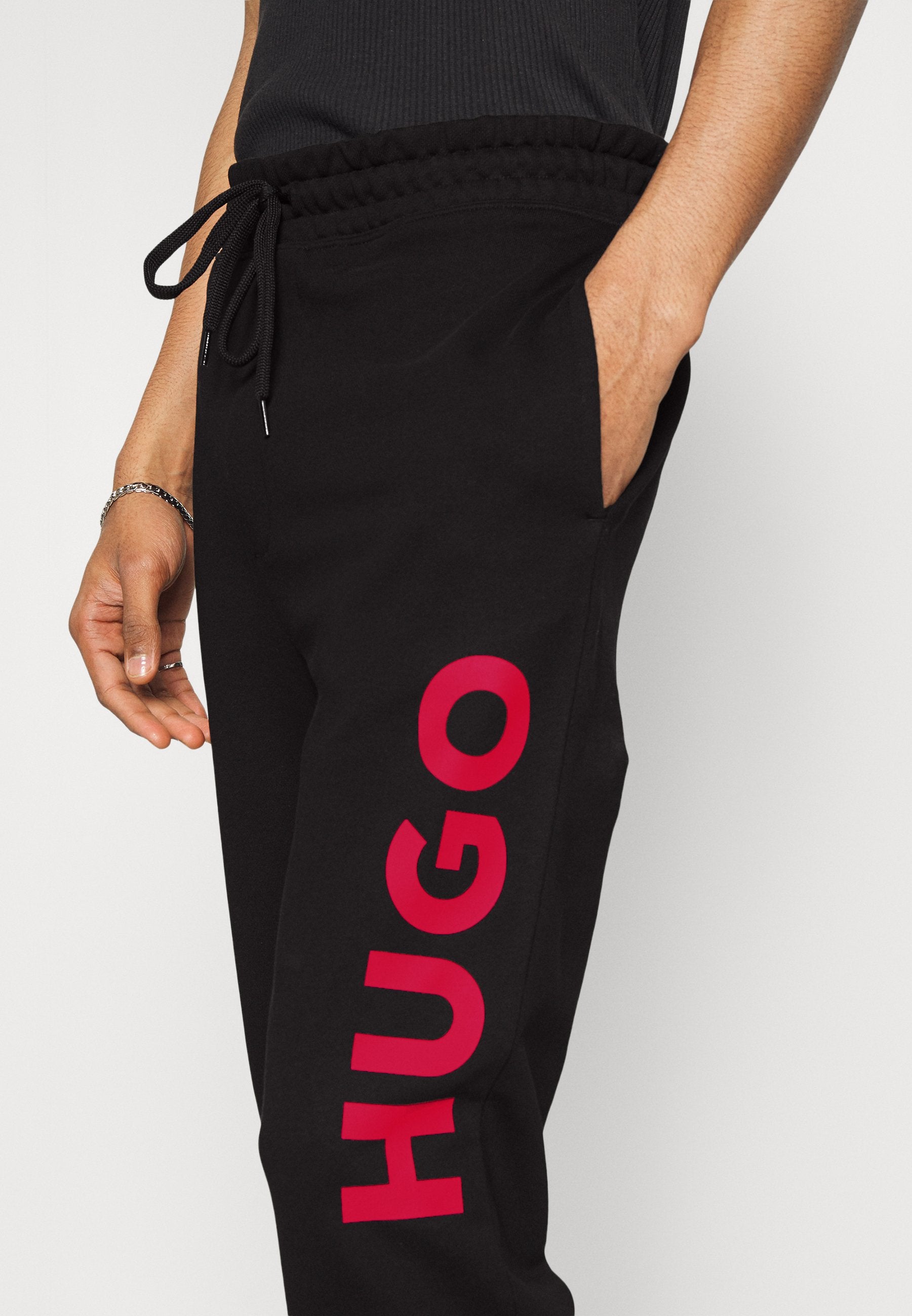 DUTSCHI - Tracksuit bottoms - black