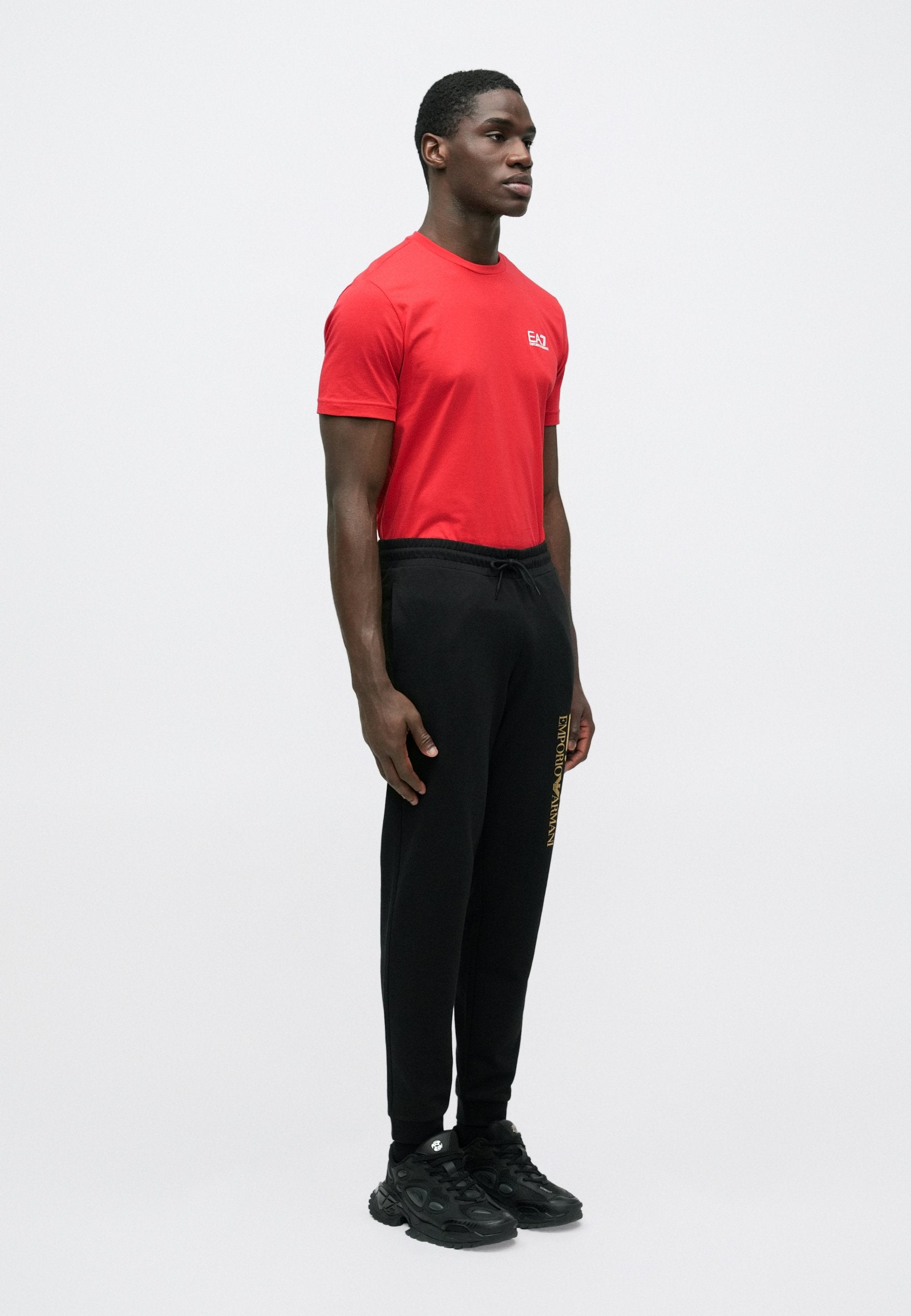 TRAIN CORE BIG LOGO PANTS - Tracksuit bottoms - black/gold-coloured