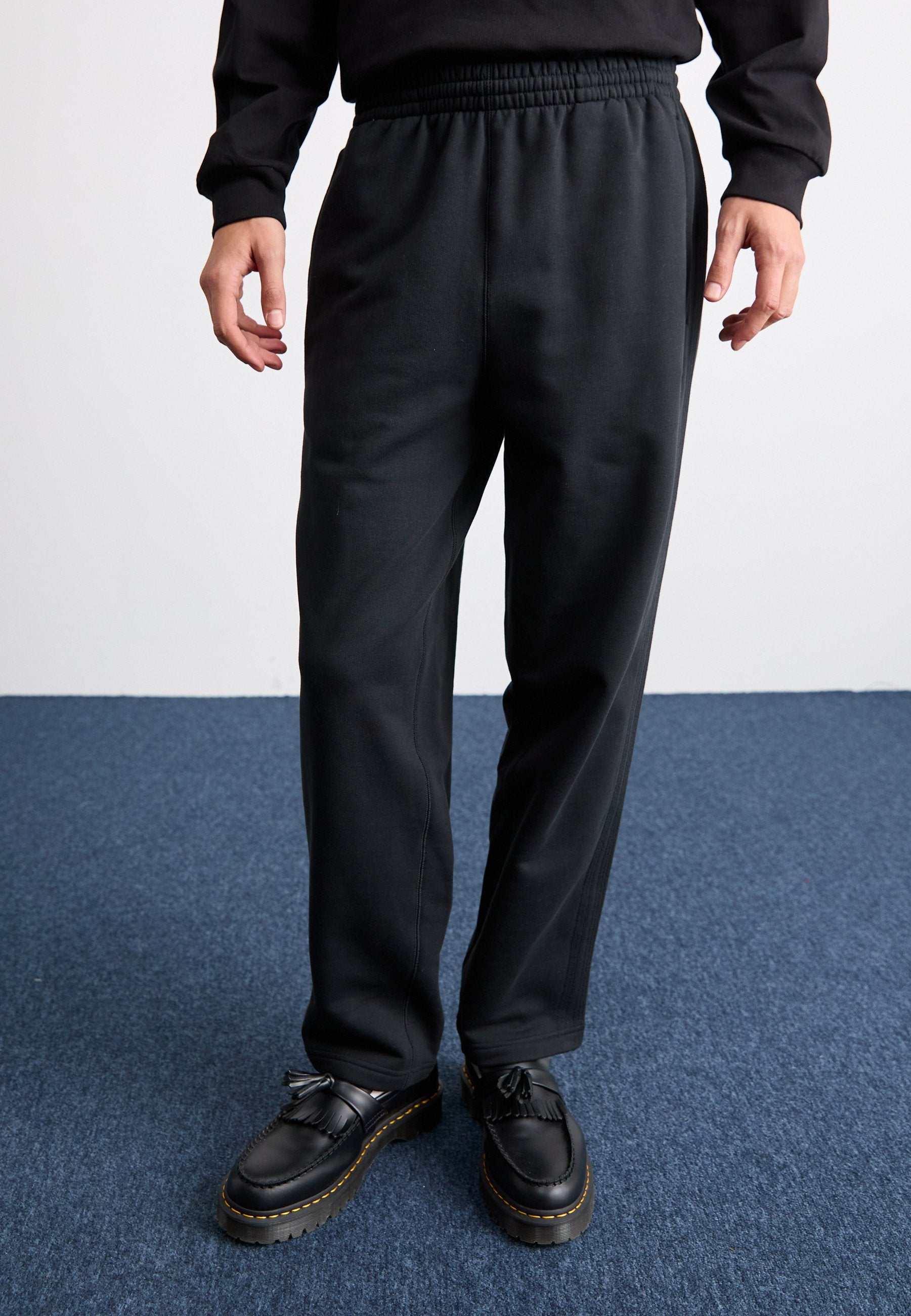 WIDE - Tracksuit bottoms - black