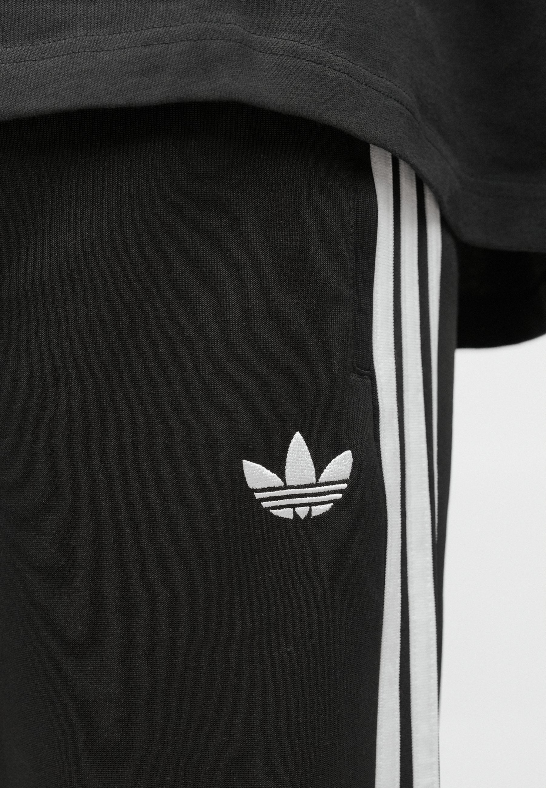 SST TP - Tracksuit bottoms - black