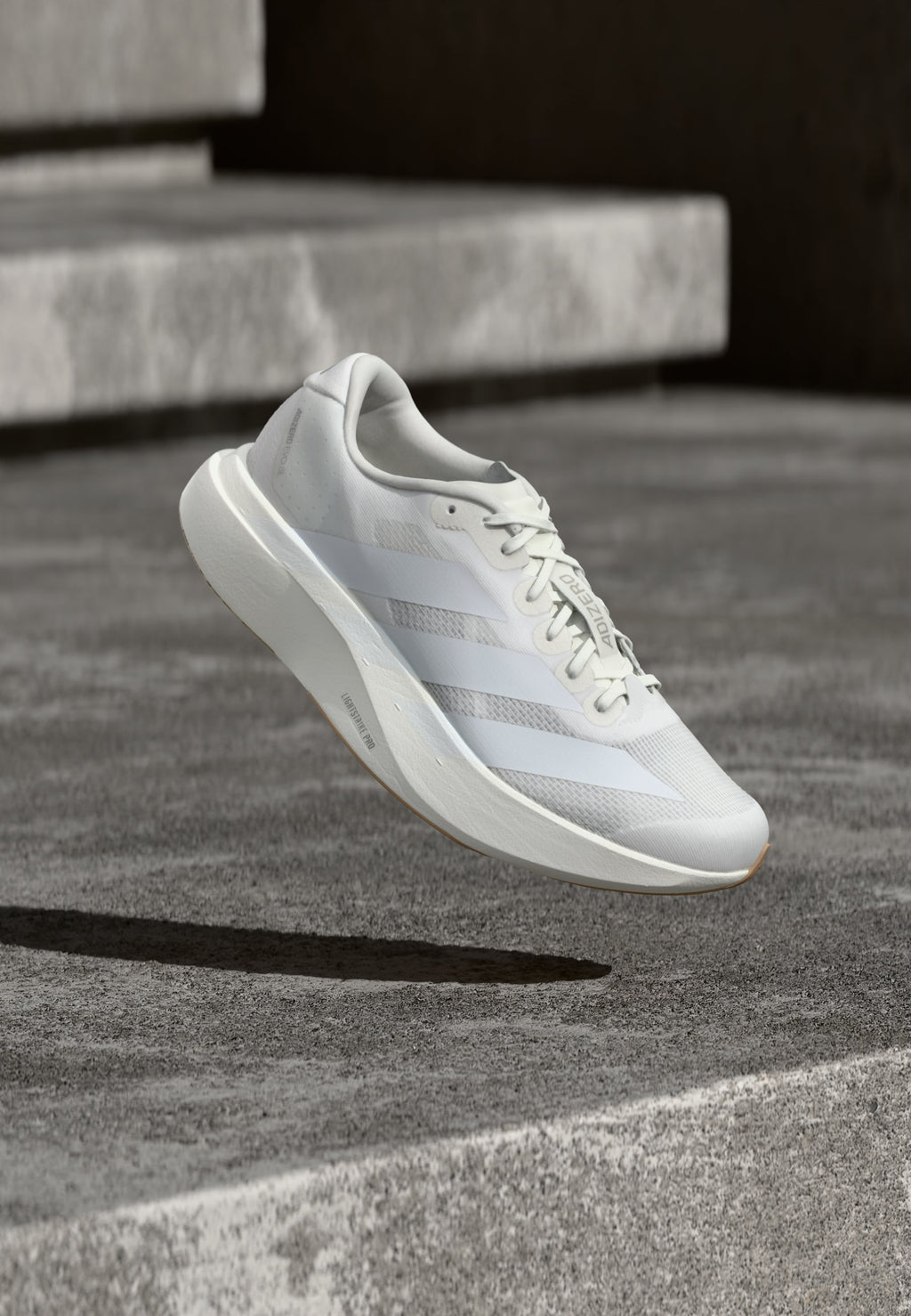 ADIZERO EVO SL M - Trainers - footwear white/warm sandstone
