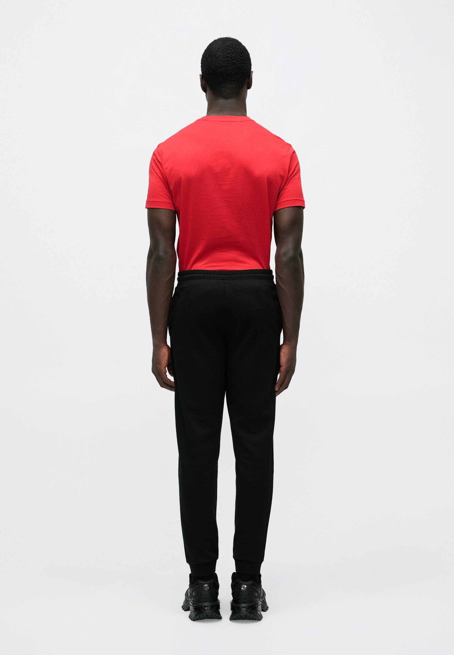 TRAIN CORE BIG LOGO PANTS - Tracksuit bottoms - black/gold-coloured