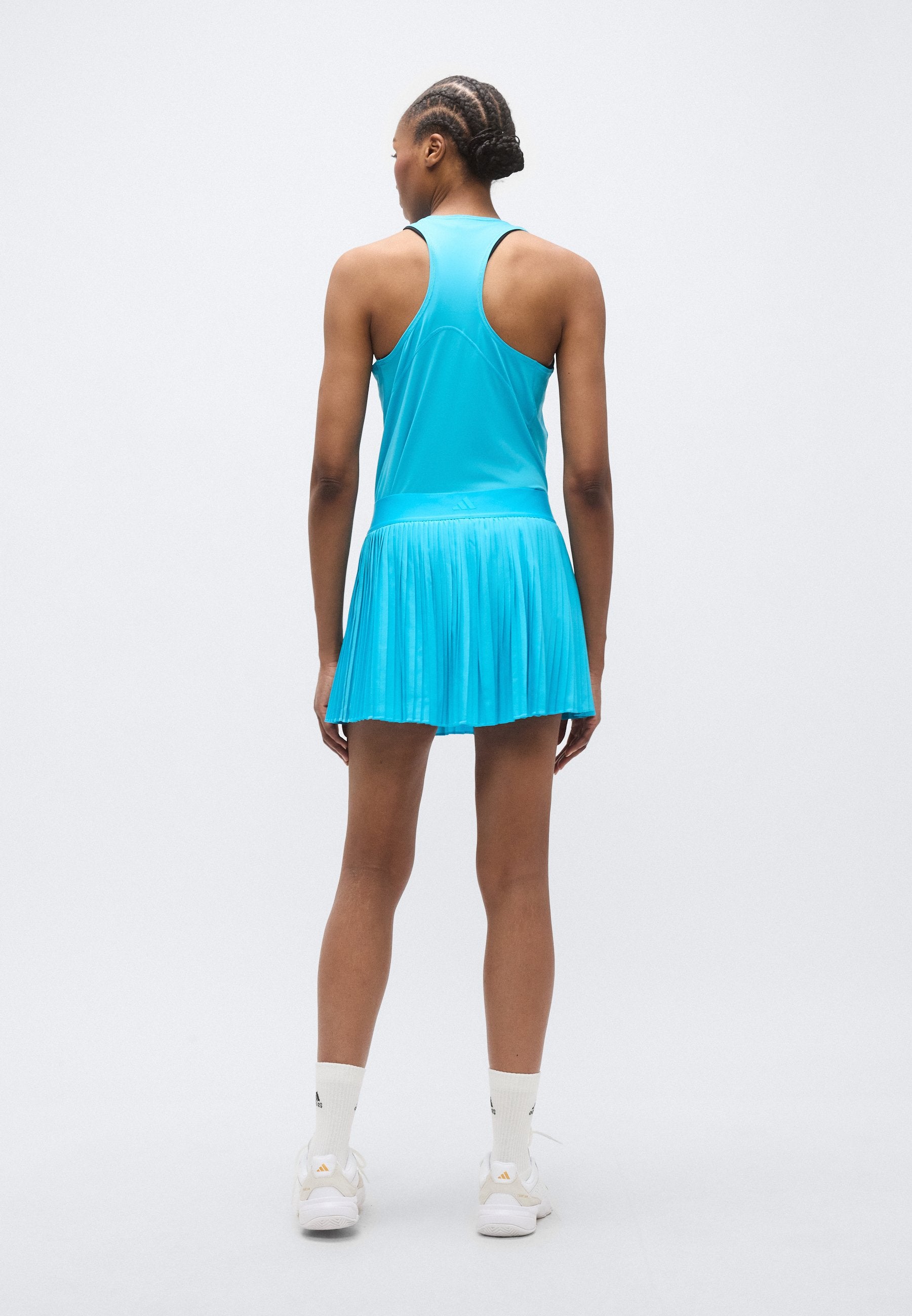 تنورة رياضية CLUB PLEATSKIRT - سيان إشارة
